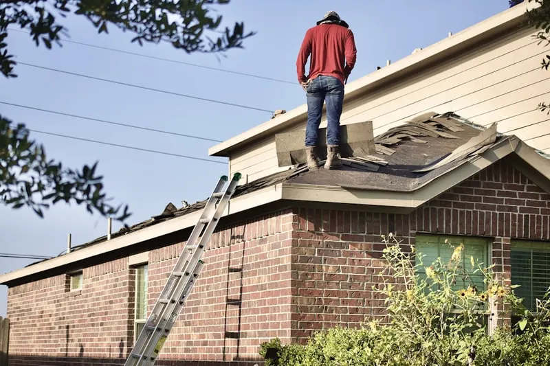 Professional roofer working on a residential roof in The Country